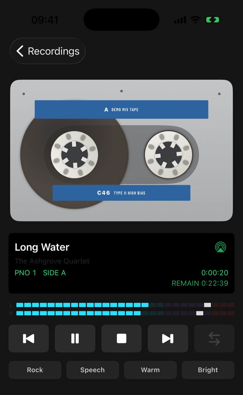 The player on an iPhone: a cassette with its reels turning, the track and artist, the counter and side, level meters and transport keys